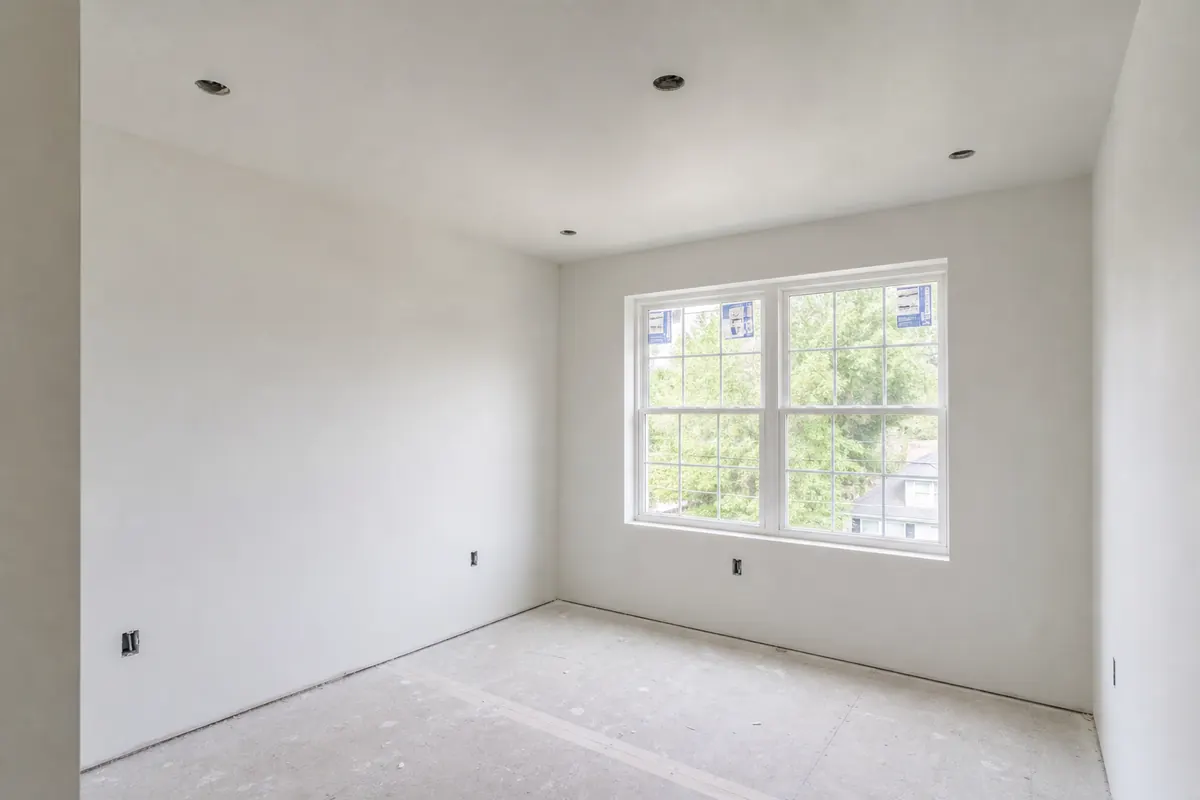 Freshly finished drywall in a Chester County bedroom — smooth walls, clean corners
