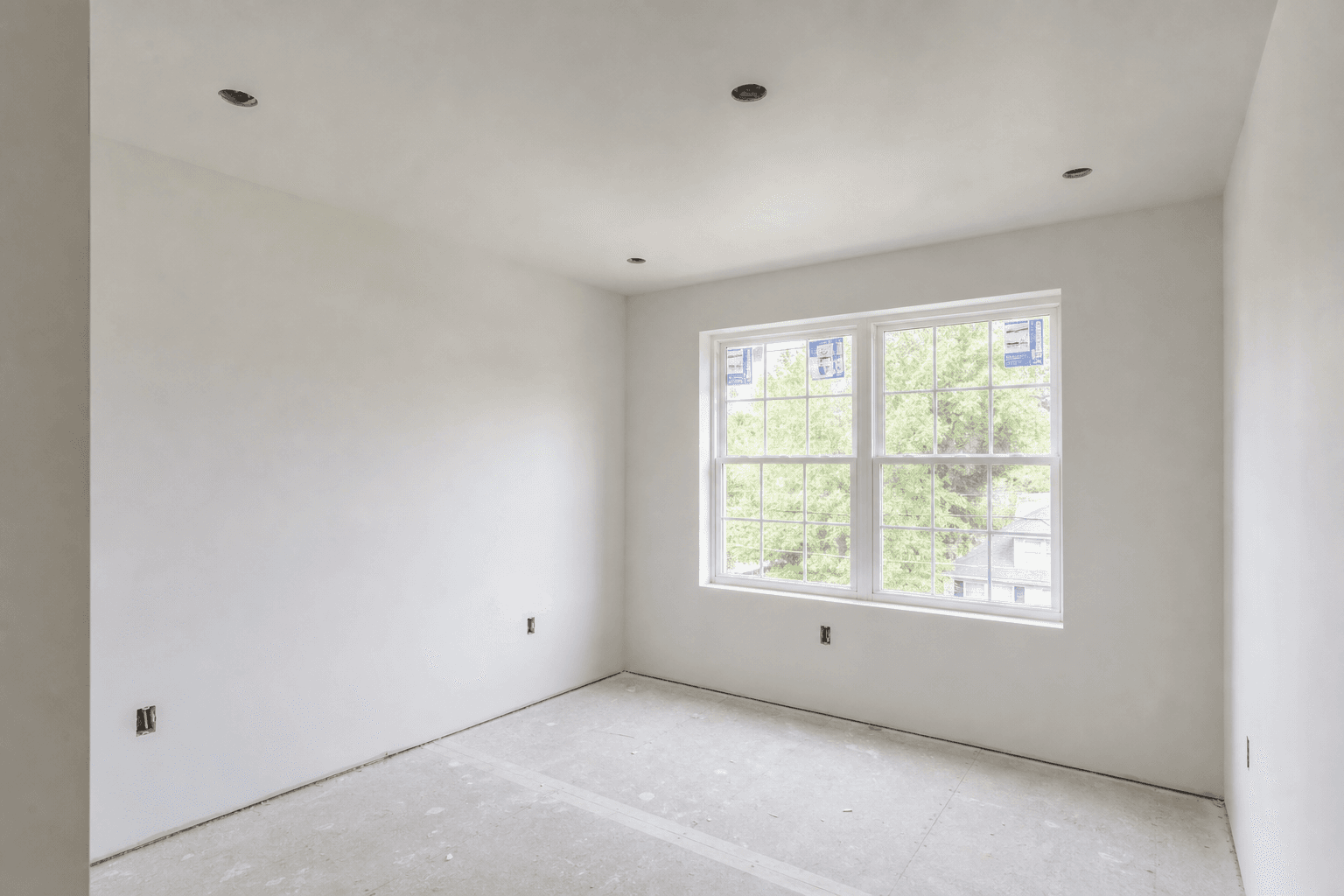 Freshly finished drywall in a Chester County bedroom — smooth walls, clean corners